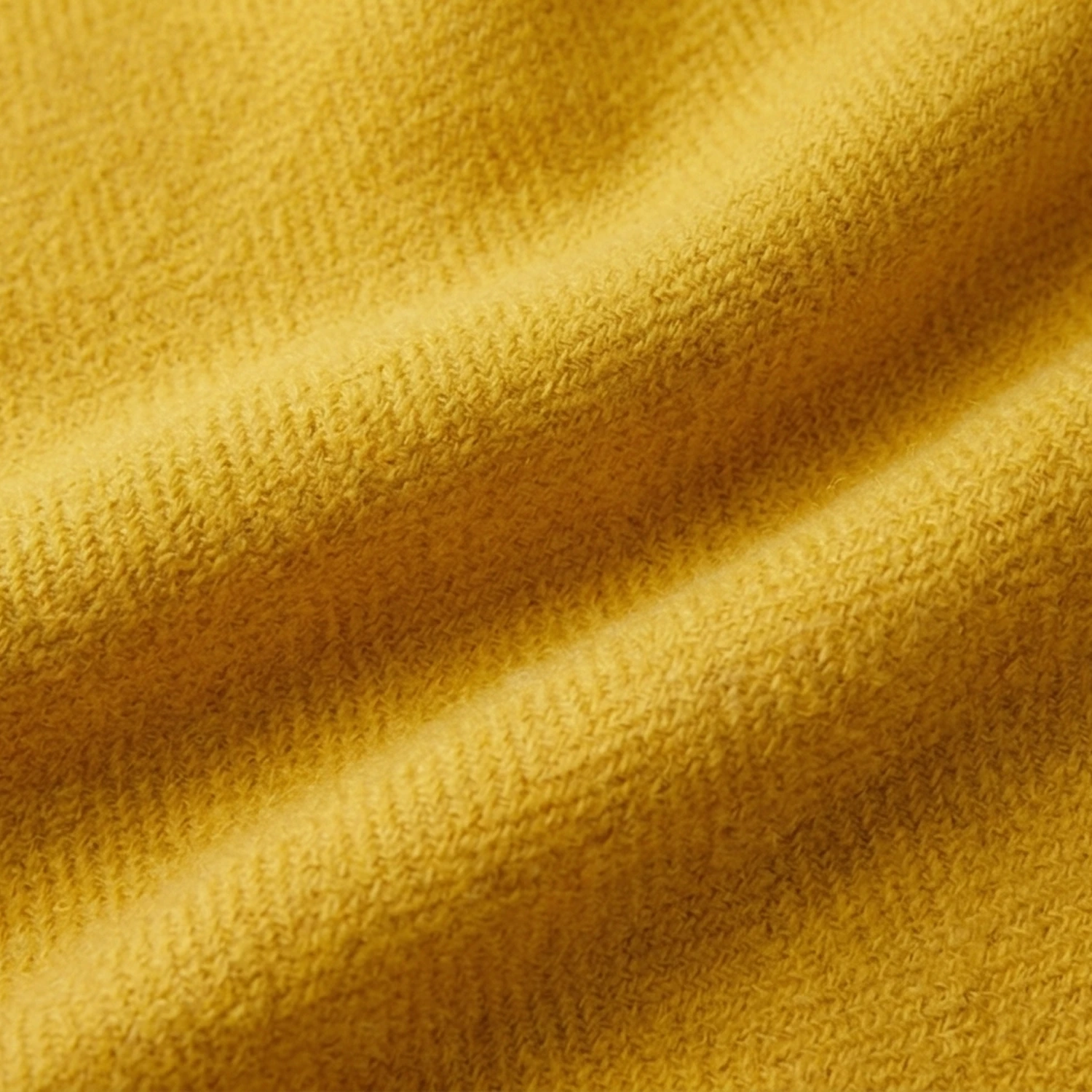 Close-up of mustard yellow knit fabric.